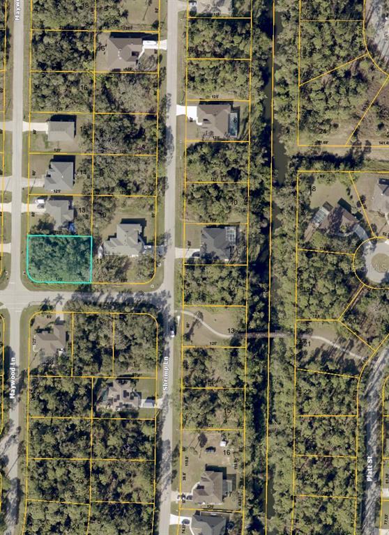 This is an aerial map showing a vacant lot highlighted in blue within a residential neighborhood — MAYWOOD LANE, NORTH PORT, FL