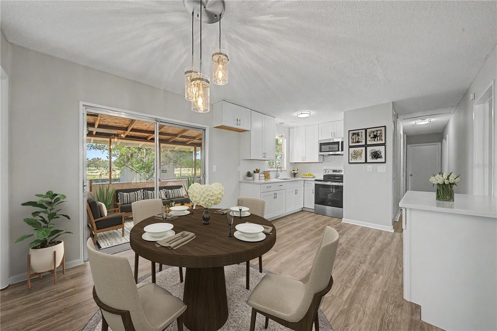 A dining area with a round table and pendant lighting opens to a covered patio — 4717 HOWARD STREET, SEBRING, FL