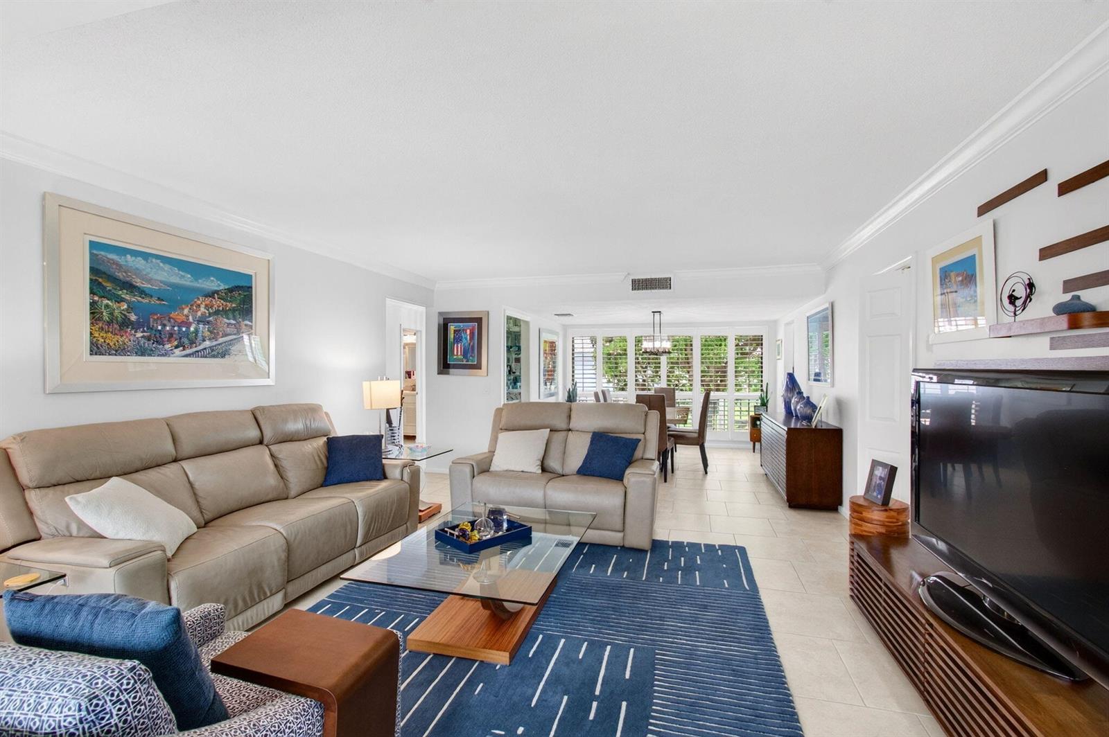 A living room with light tile floors, a blue area rug, and two beige sofas — 4084 N Quail Ridge Drive Unit B, Boynton Beach FL 33436, BOYNTON BEACH, FL
