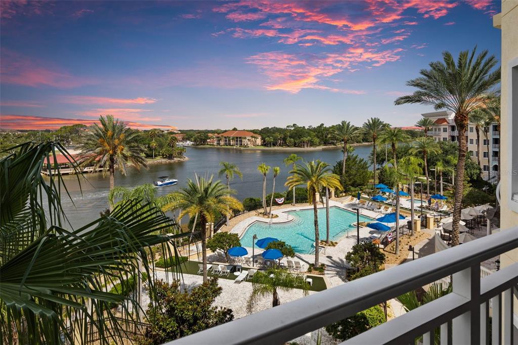 A high-angle view of a swimming pool and a river at sunset — 102 YACHT HARBOR DRIVE UNIT 467, PALM COAST, FL