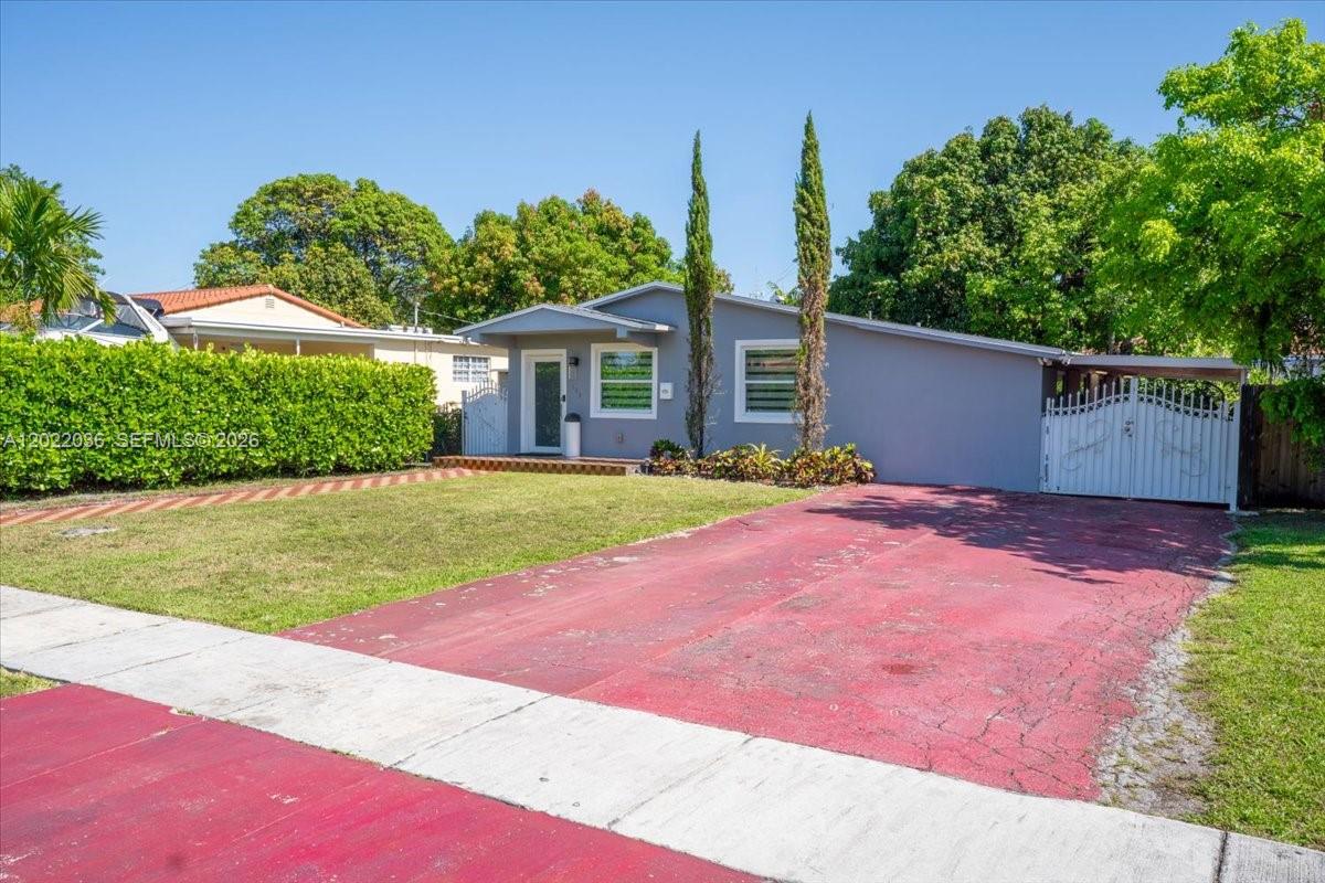 A single-story house with a gray exterior, a red driveway, and a white gate — 120 W 50th St, Hialeah FL 33012, HIALEAH, FL