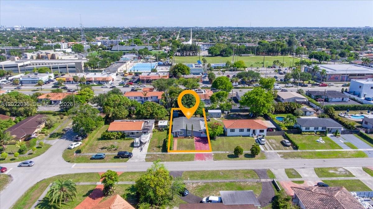 An aerial view shows a single-story house with a red driveway and orange roof — 120 W 50th St, Hialeah FL 33012, HIALEAH, FL