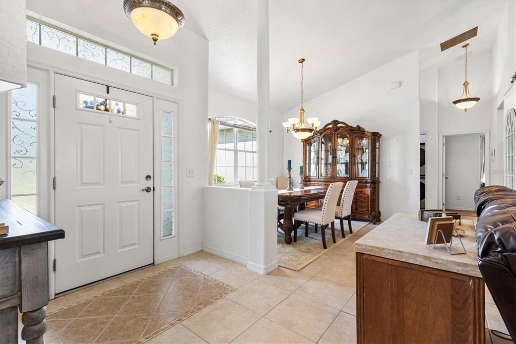 An entryway with tiled floors leads to a dining area featuring a wooden hutch — 12107 EAGLE POINT COURT, LEESBURG, FL