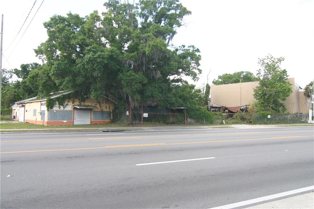 An exterior view shows a small commercial building next to a large tree and lot — 2720 OLD WINTER GARDEN ROAD, ORLANDO, FL