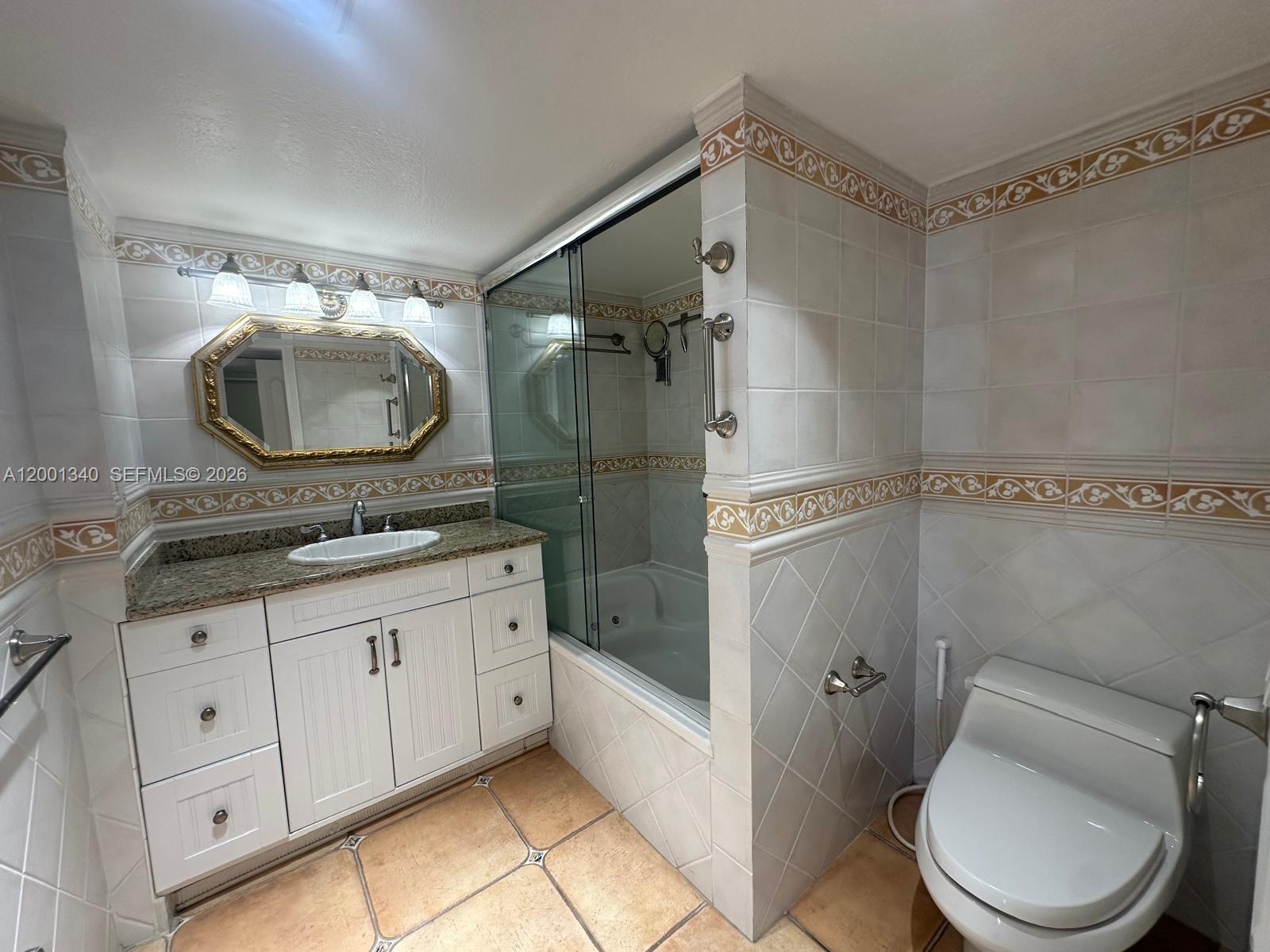 A room with tiled floors and sliding glass doors opening to a balcony overlooking the ocean — 2555 Collins Ave # 711, Miami Beach FL 33140, MIAMI BEACH, FL