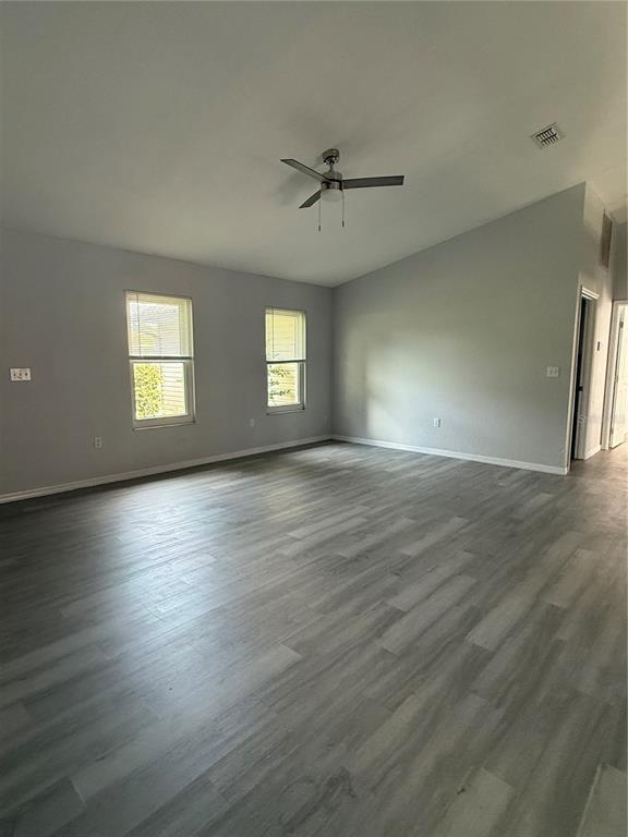 An empty room with light gray walls, wood-look flooring, and a ceiling fan — 22 HEMLOCK TERRACE, OCALA, FL