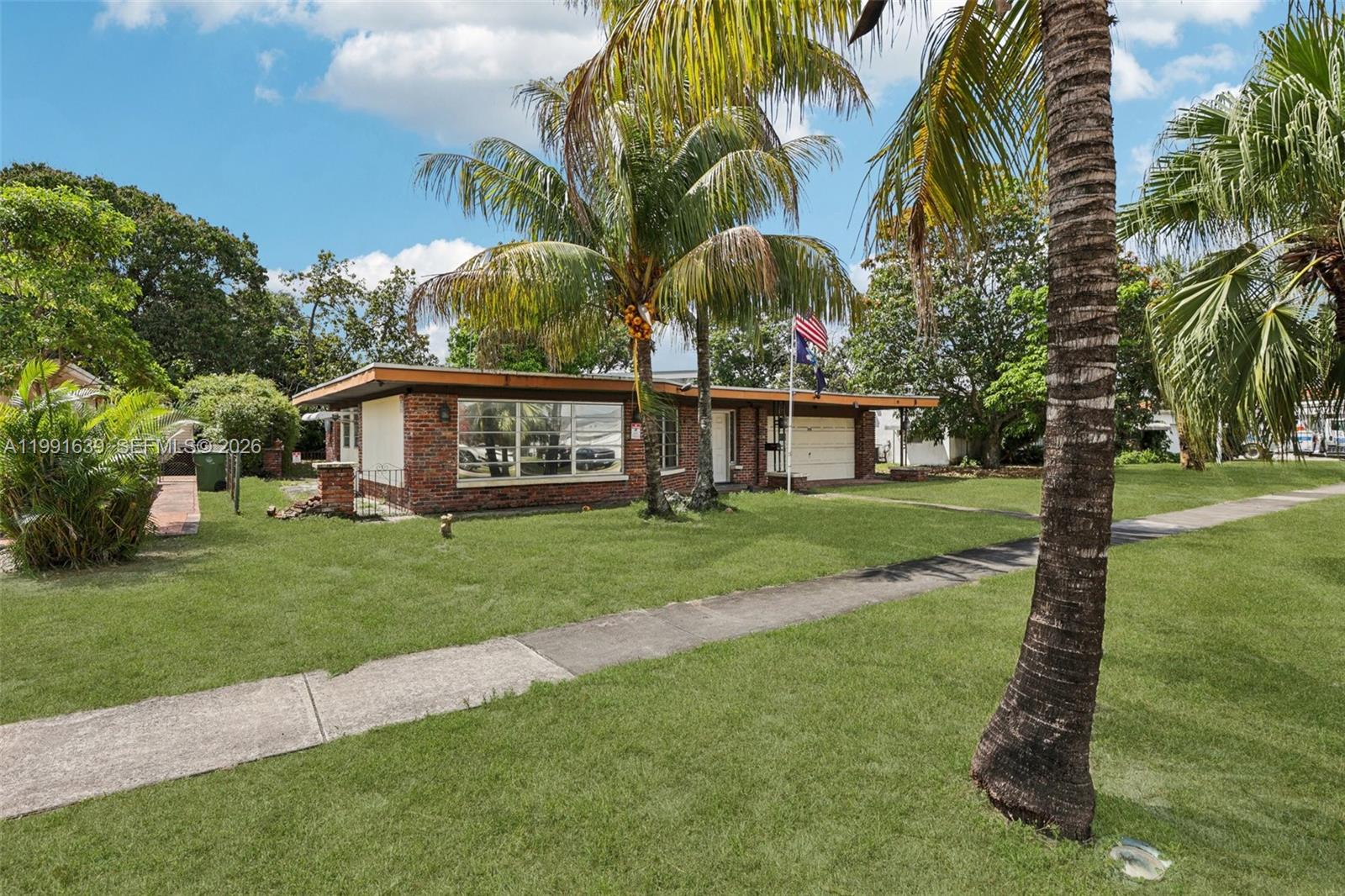 A single-story brick house with a flat roof and a front lawn with palm trees — 272 W 46th St, Hialeah FL 33012, HIALEAH, FL