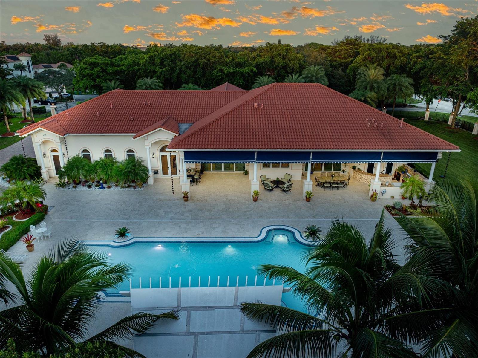 An aerial view of a house with a red tile roof, pool, and covered patio — 5801 Estates Drive, Southwest Ranches FL 33330, SOUTHWEST RANCHES, FL