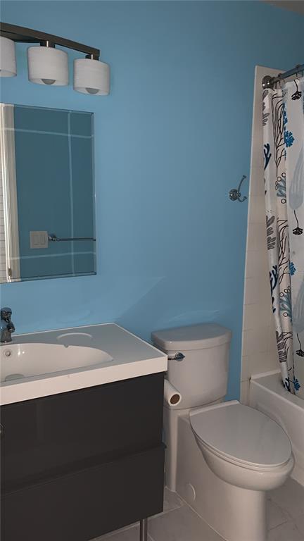 A bathroom features a blue wall, a dark vanity with a white sink, and a toilet — 1949 SUMMER CLUB DRIVE UNIT 311, OVIEDO, FL