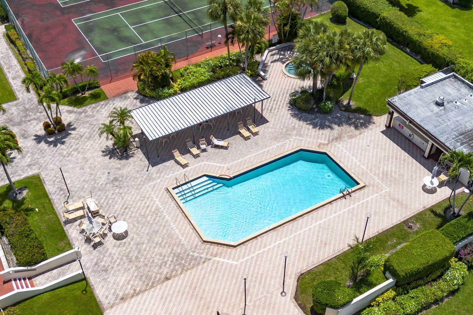 An aerial view shows a swimming pool, tennis court, patio area, and surrounding landscaping — 6320 Lakemont Circle, FL 33463, FL