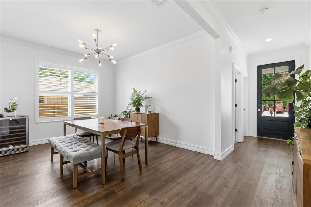 A dining room features a wooden table, a tufted bench, and a modern light fixture — 2510 W CARMEN STREET, TAMPA, FL