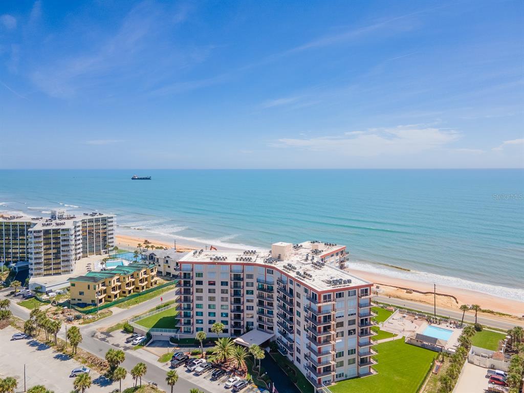 An aerial view of a beachfront condominium complex with a swimming pool and ocean views — 3600 S OCEAN SHORE BOULEVARD UNIT 720, FLAGLER BEACH, FL