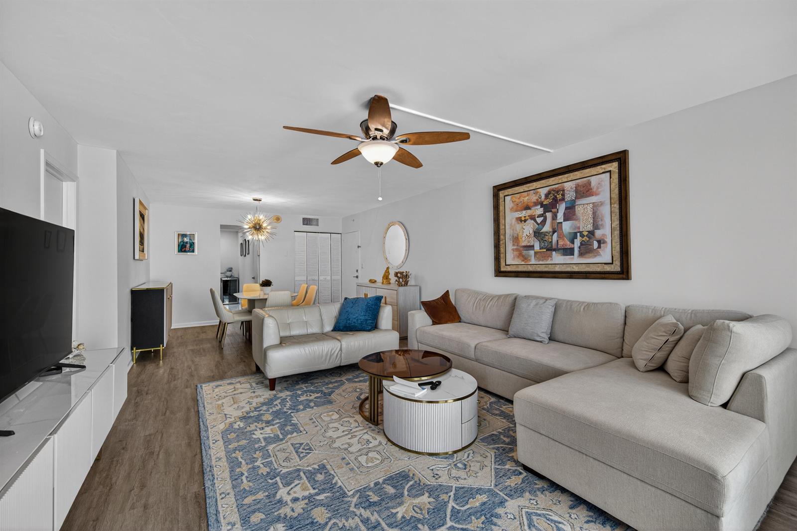 A living room features a sectional sofa, a patterned area rug, and a ceiling fan — 1370 S Ocean Boulevard # 306, Pompano Beach FL 33062, POMPANO BEACH, FL