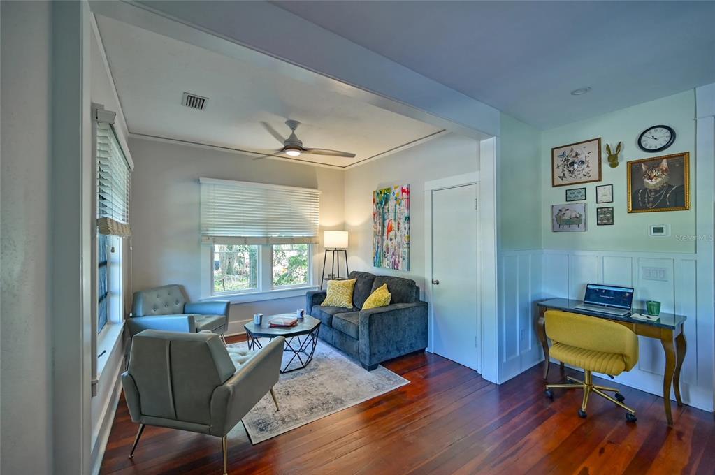 A living room features hardwood floors, a gray sofa, two armchairs, and a small desk — 2408 HILLVIEW STREET, SARASOTA, FL