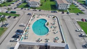 An aerial view shows a kidney-shaped swimming pool surrounded by a patio and parking lots — 340 W Horizons # 205, Boynton Beach FL 33435, BOYNTON BEACH, FL