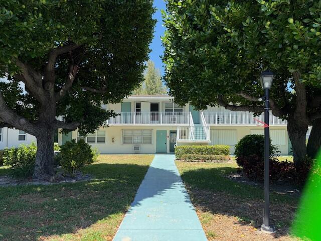 A two-story apartment building with a blue walkway and large trees in the front yard — 340 W Horizons # 205, Boynton Beach FL 33435, BOYNTON BEACH, FL
