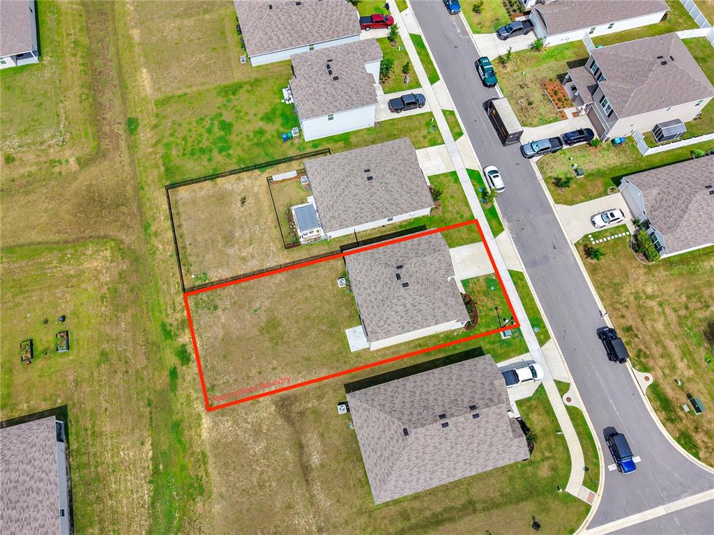 An aerial view shows a single-family home with a large backyard outlined in red — 17627 NW 172ND AVENUE, ALACHUA, FL