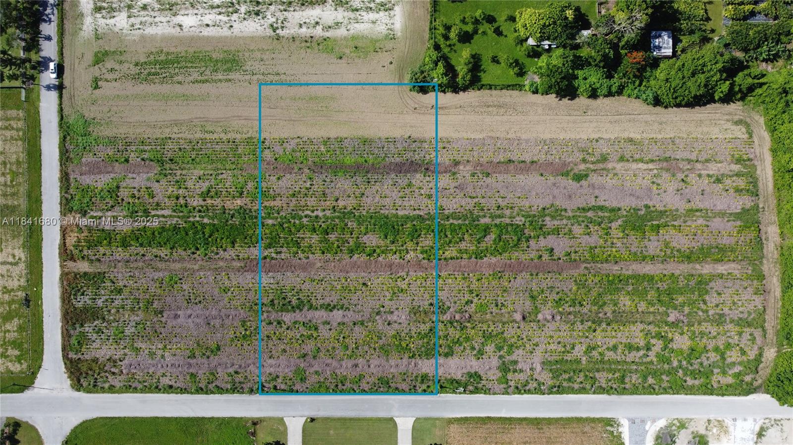 An aerial view shows a rectangular plot of land outlined in blue along a road — 213th PL SW 240th ST, Miami FL 33031, MIAMI, FL