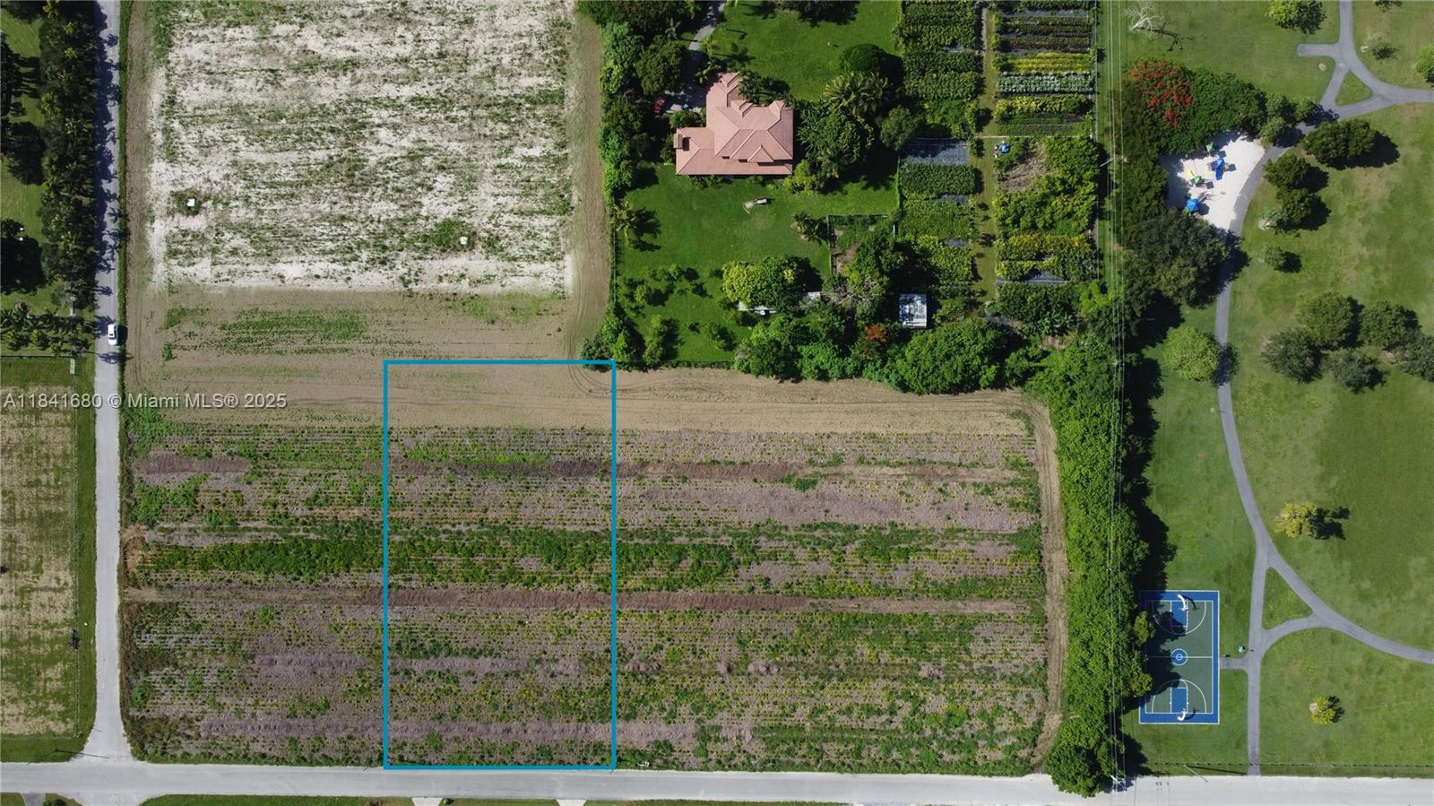 This is an aerial view of a rectangular plot of land outlined in blue — 213th PL SW 240th ST, Miami FL 33031, MIAMI, FL