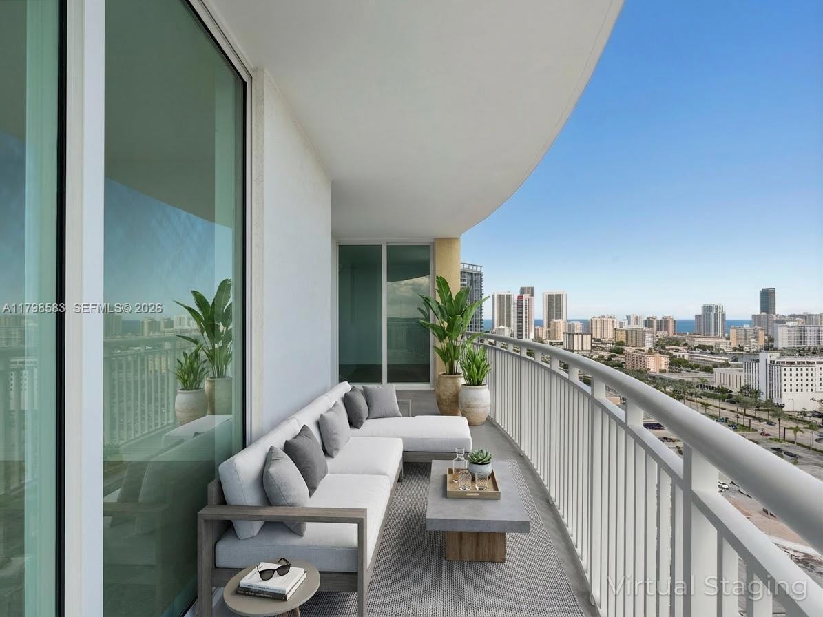 A balcony with outdoor furniture, potted plants, and a view of the city skyline — 1745 E Hallandale Beach Blvd # 2007W, Hallandale Beach FL 33009, HALLANDALE BEACH, FL