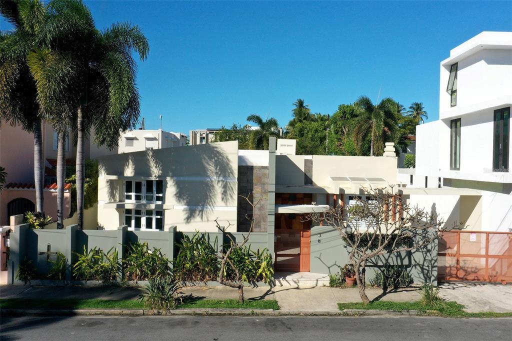 A modern, single-story house with a flat roof, stone accents, and a gated front entrance — 2003 ESPANA, SAN JUAN, PR