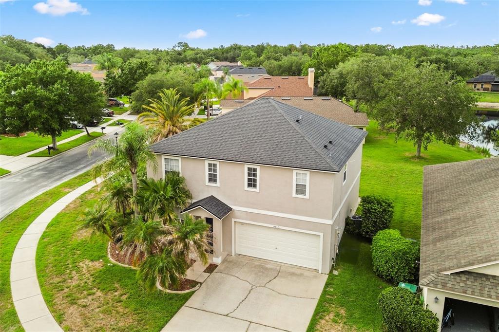 An aerial view of a two-story suburban house with a gray roof and garage — 14837 HUNTLEY DRIVE, ORLANDO, FL