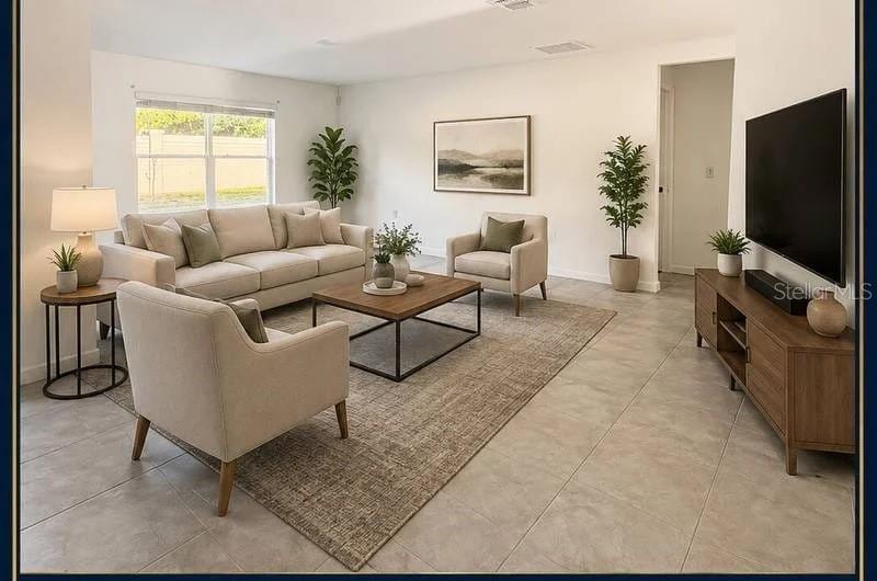 A living room with a beige sofa, two armchairs, a coffee table, and a television — 3417 YARIAN DRIVE, HAINES CITY, FL