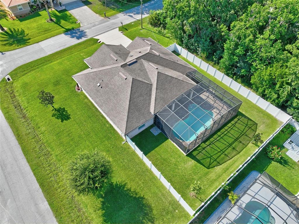 An aerial view of a single-story house with a screened-in pool and a fenced yard — 2 LYTTON LANE, PALM COAST, FL