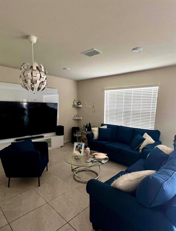 A dining area features a white glass table, a corner bench, and a matching bench seat — 17148 CAGAN CROSSINGS BOULEVARD, CLERMONT, FL