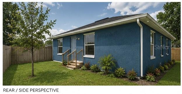 A blue stucco house exterior features a small wooden staircase leading to a side door — 2307 N 48TH STREET, TAMPA, FL