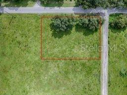 An aerial view shows a rectangular plot of land outlined in red on a grassy lot — CR 763, BUSHNELL, FL