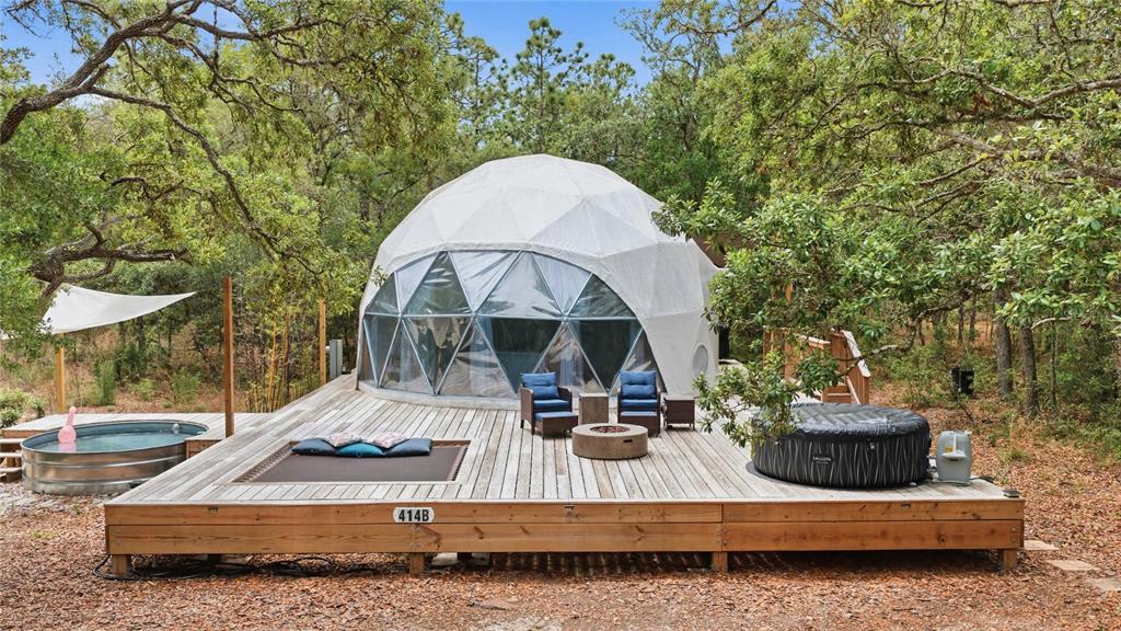 A geodesic dome structure sits on a wooden deck with a hot tub and pool — 414 S SCHOOL AVENUE, LECANTO, FL