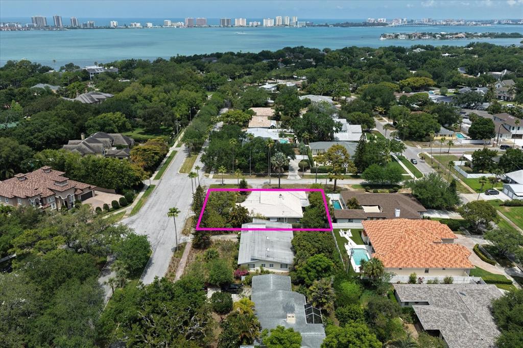 An aerial view shows a residential property highlighted by a pink border in a neighborhood — 109 PONCE DE LEON BOULEVARD, BELLEAIR, FL