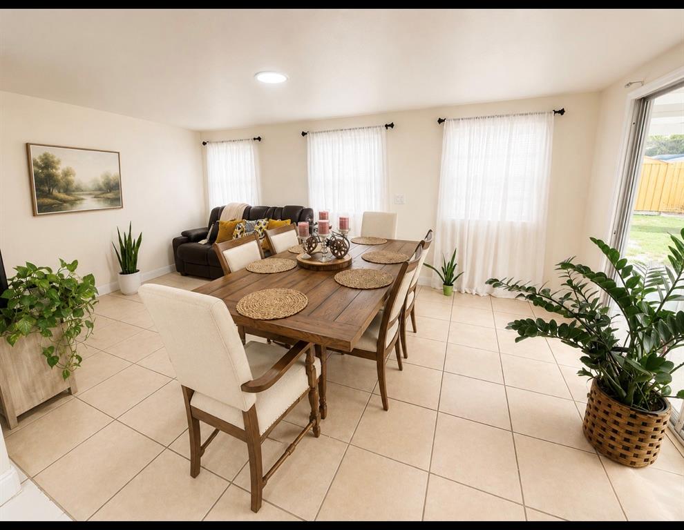 A dining room with a wooden table, upholstered chairs, tile flooring, and large windows — 1618 CRYSTALVIEW TRAIL, LAKELAND, FL