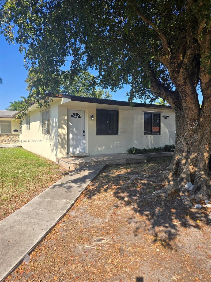 A single-story house with a white exterior, a front porch, and a large tree nearby — 457 NE 140th St # 1, North Miami FL 33161, NORTH MIAMI, FL