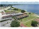 An aerial view shows a multi-unit residential complex situated along a large body of water — 1001 LAKEVIEW DRIVE, SEBRING, FL