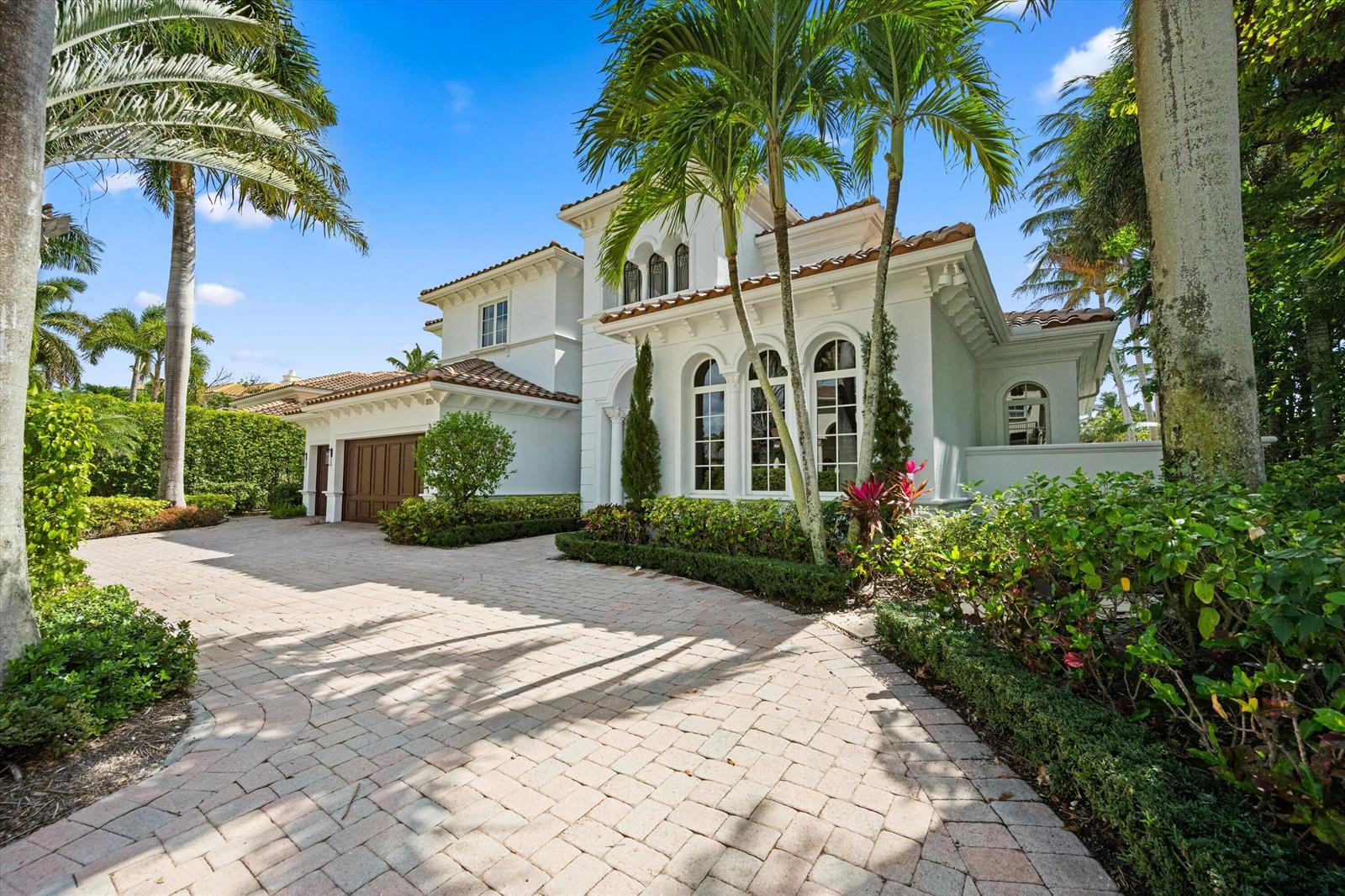 A two-story white stucco house with a tiled roof and a paved driveway — 788 Harbour Isles Place, North Palm Beach FL 33410, NORTH PALM BEACH, FL