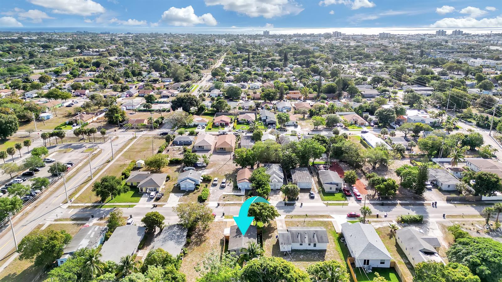 An aerial view shows a residential neighborhood with a light blue arrow pointing to a house — 240 NW 9th Avenue, Delray Beach FL 33444, DELRAY BEACH, FL
