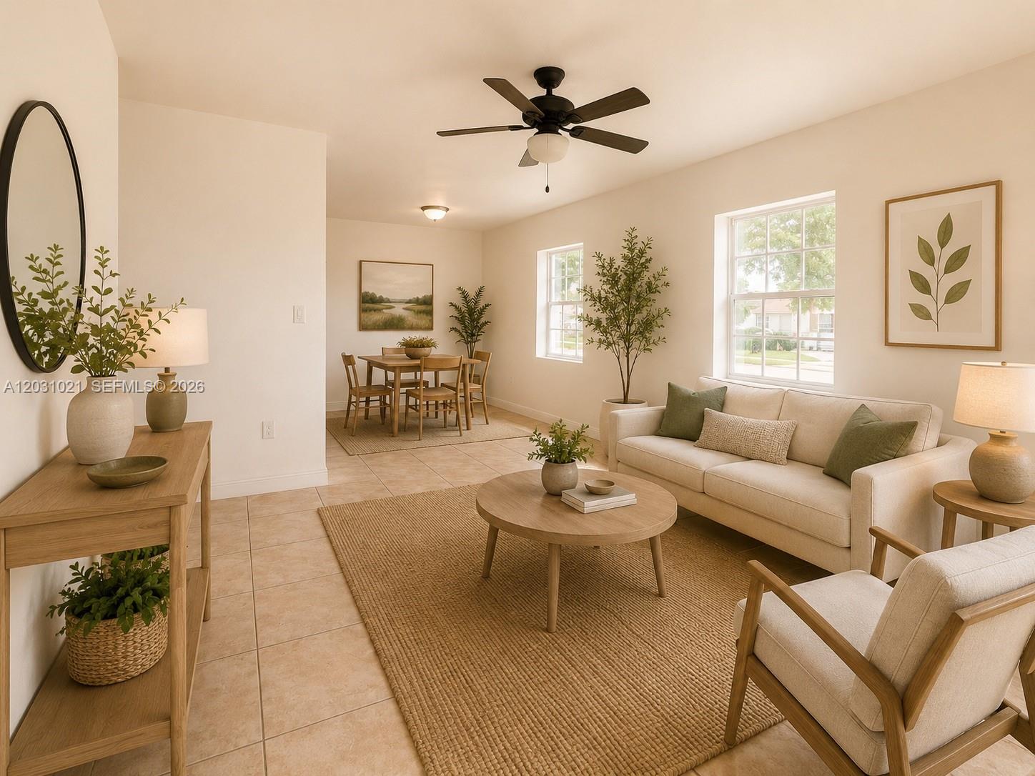A bright living and dining area features neutral furniture, tile flooring, and two large windows — 15410 NW 29th Ct # A, Miami FL 33054, MIAMI, FL