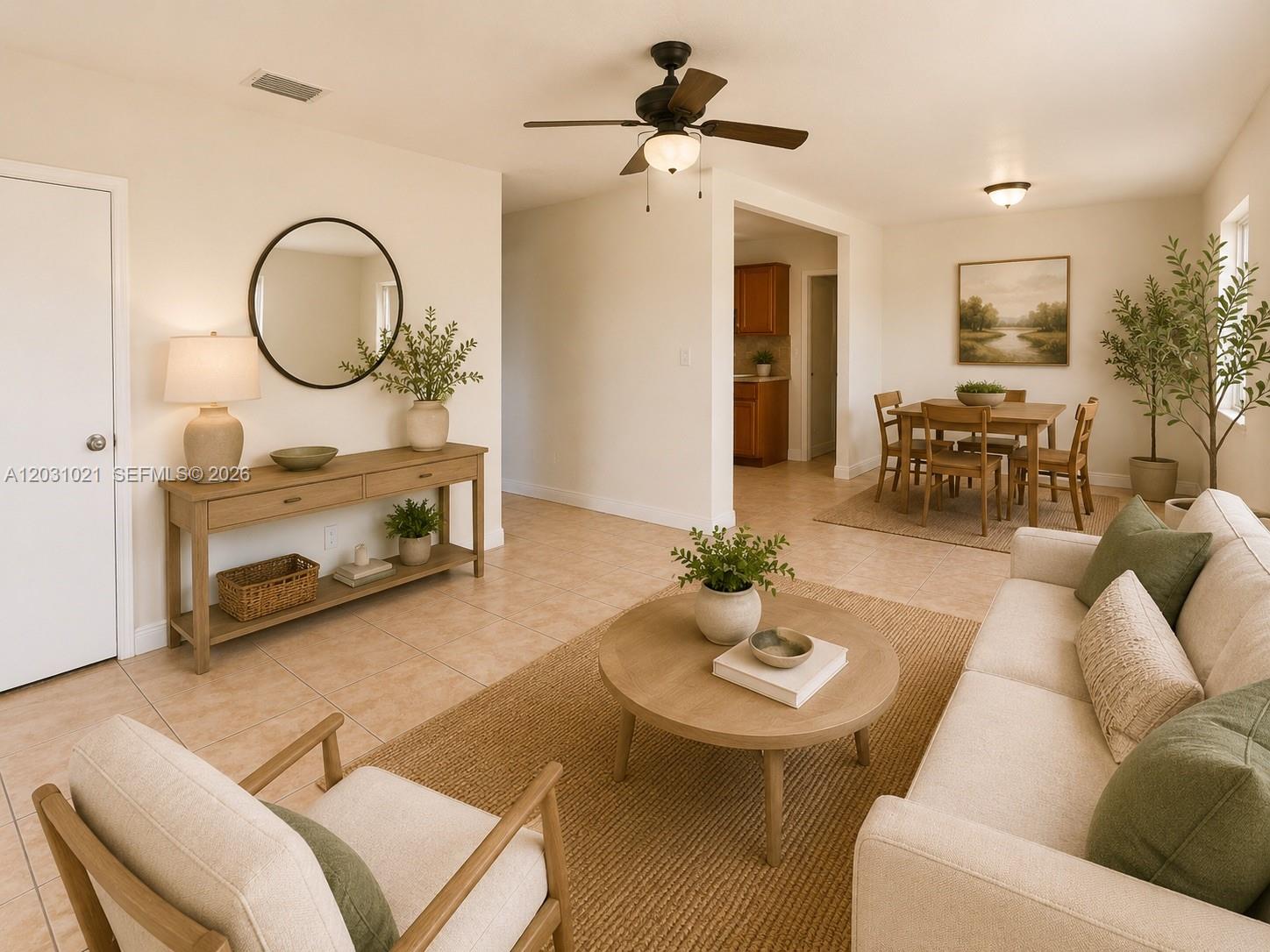 A living room and dining area feature neutral furniture, tile flooring, and a ceiling fan — 15410 NW 29th Ct # A, Miami FL 33054, MIAMI, FL