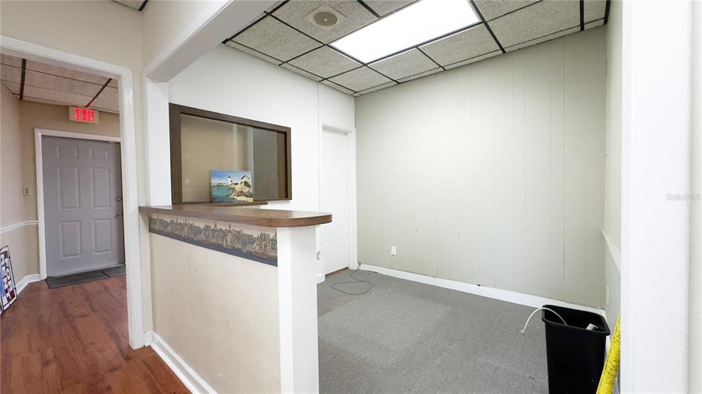 An office space features a reception counter, a drop ceiling, and a gray door — 3612 5TH AVENUE N, ST PETERSBURG, FL