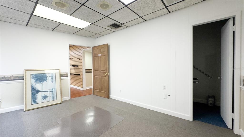An interior room with white walls, gray carpeting, a drop ceiling, and two open doorways — 3612 5TH AVENUE N, ST PETERSBURG, FL