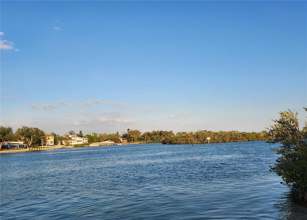 A view of a calm waterway with houses on the left and mangroves on the right — 100 CIRCUIT ROAD UNIT S127, NOKOMIS, FL