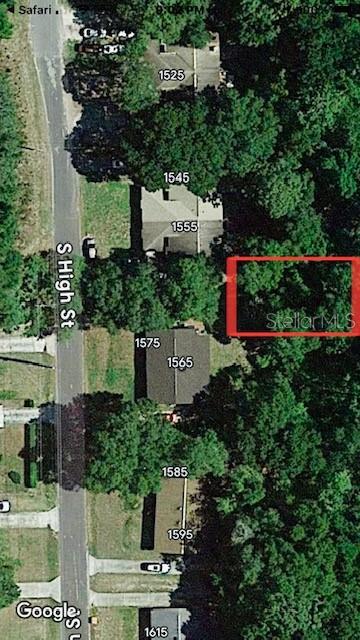 This aerial map shows a vacant, wooded lot highlighted in red between two residential properties — NO STREET, DELAND, FL