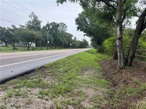 A paved road runs alongside a grassy shoulder with trees and a wooden fence — 2115 N Cr 78 Road, FL 33935, FL