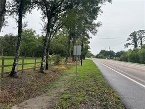 A grassy roadside area with a wooden fence, several trees, and a blank road sign — 2115 N Cr 78 Road, FL 33935, FL
