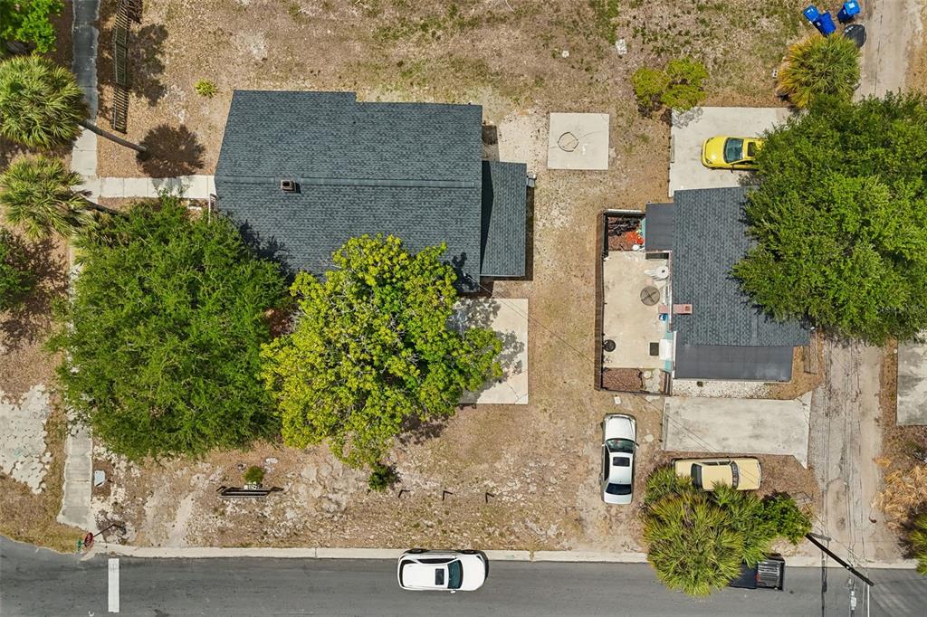 An aerial view shows two houses on a lot with trees, driveways, and parked cars — 4105 18TH AVENUE S, ST PETERSBURG, FL