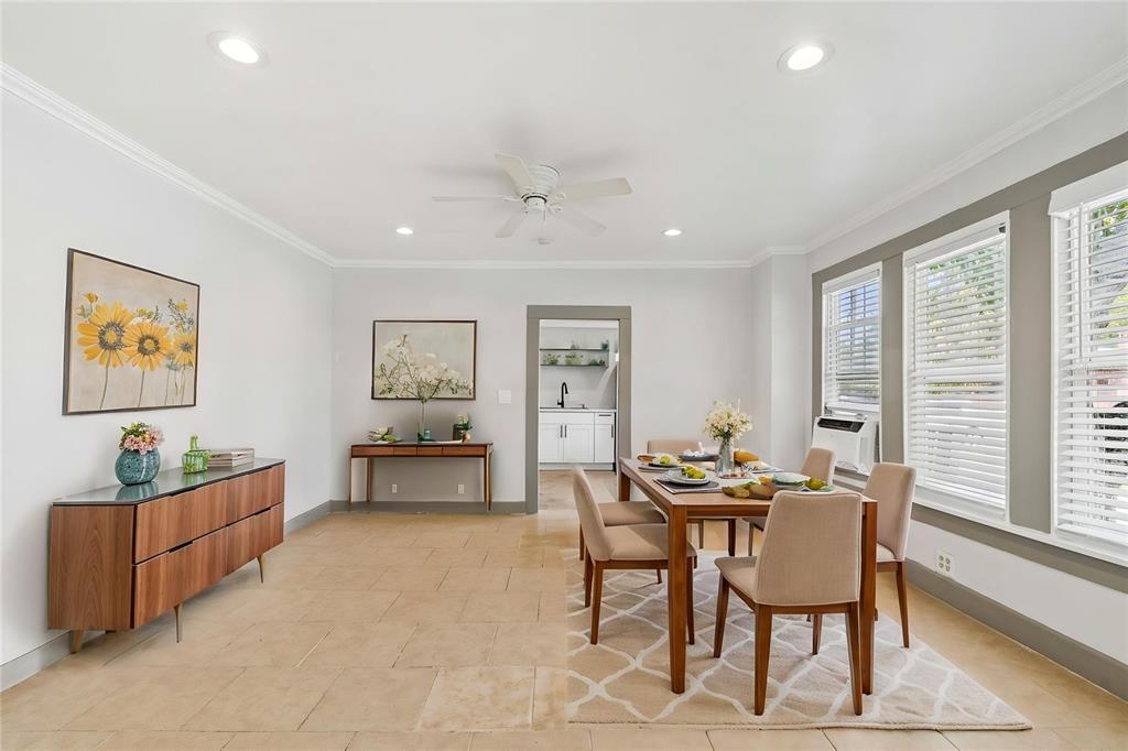 A dining room features tile flooring, a wooden table with chairs, and a side cabinet — 4105 18TH AVENUE S, ST PETERSBURG, FL