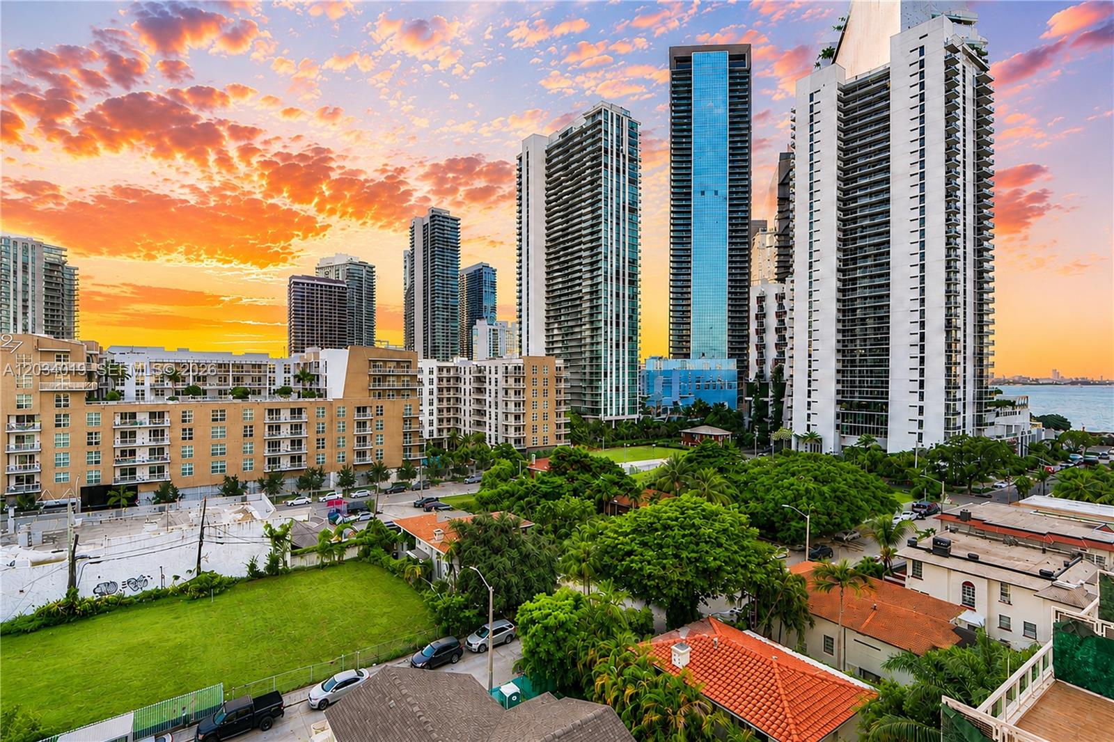 An elevated view of a city skyline with modern high-rise buildings at sunset — 321 NE 26th St # 806, Miami FL 33137, MIAMI, FL