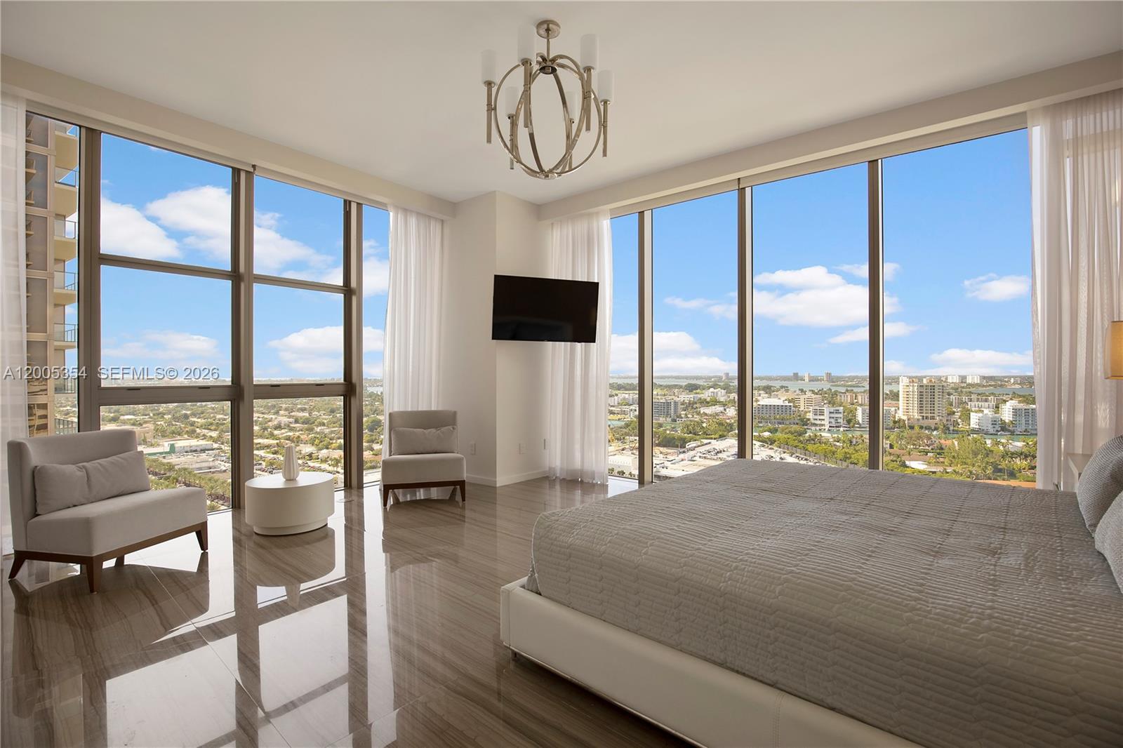 A modern bedroom features floor-to-ceiling windows, a king bed, and glossy tile flooring — 9705 Collins Ave # 1805N, Bal Harbour FL 33154, BAL HARBOUR, FL